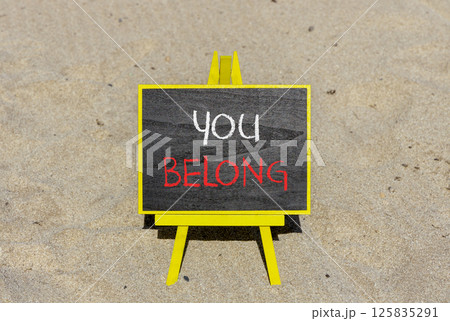 Belonging and you belong symbol. Concept words You belong on beautiful yellow chalk blackboard. Beautiful sand beach background. Business belonging and you belong concept. Copy space. Belonging and you belong symbol. Concept words You belong on beautiful yellow chalk blackboard. Beautiful sand beach background. Business belonging and you belong concept. Copy space. 125835291