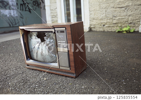 old broken TV left on the street. 125835554