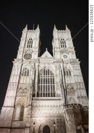 Westminster Abbey stands majestically lit against the night sky in London. Its intricate architecture and towering spires are highlighted, creating a breathtaking view for evening visitors. Westminster Abbey stands majestically lit against the night sky in London. Its intricate architecture and towering spires are highlighted, creating a breathtaking view for evening visitors. 125836625