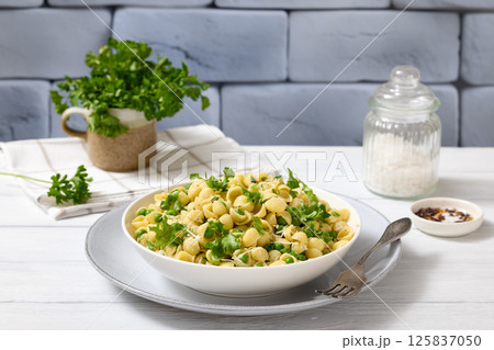 Pasta with green peas in a bowl, italian cuisine Pasta with green peas in a bowl, italian cuisine 125837050