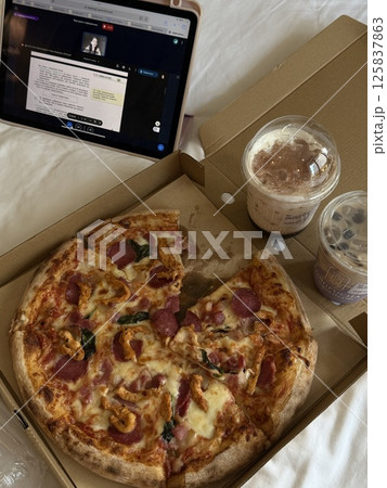 online lessons on tablet vertical photo Top view of business woman working on a table at a pizza restaurant 125837863