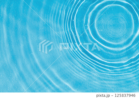 drops on water with circles on a blue background drops on water with circles on a blue background 125837946