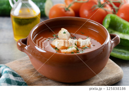 Traditional Spanish Gazpacho soup in bowl on wooden table Traditional Spanish Gazpacho soup in bowl on wooden table 125838186