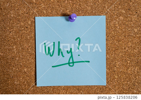 Light blue sticky note pinned to corkboard asking why Light blue sticky note pinned to corkboard asking why 125838206