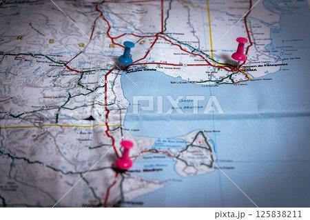 Pushpins marking locations on folded road map of argentina Pushpins marking locations on folded road map of argentina 125838211