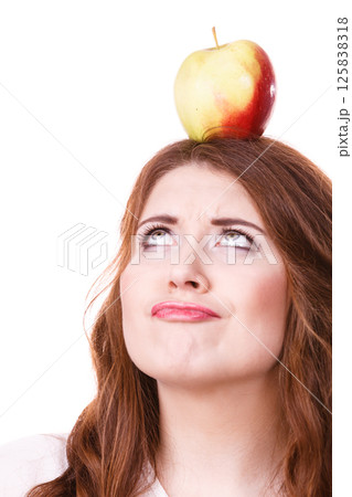 Woman holds on head apple fruit looking up 125838318