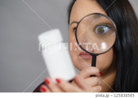 Woman investigating ingredients of medicines 125838505