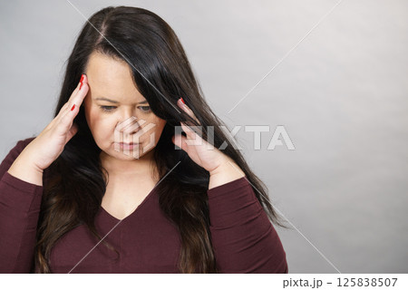 Worried woman having painfull headache 125838507