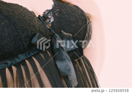 Woman in black lingerie showing her breast chest. Woman in black lingerie showing her breast chest. 125838558