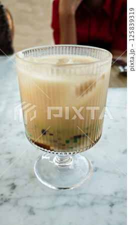 Chilled Cendol Dessert in a Clear Glass on Marble Table 125839319