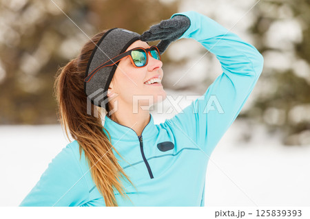 Winter workout. Girl wearing sportswear and sunglasses. Winter workout. Girl wearing sportswear and sunglasses. 125839393