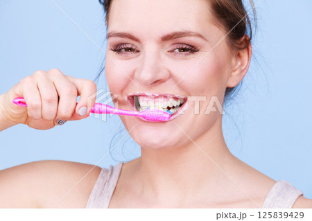 Woman brushing cleaning teeth Woman brushing cleaning teeth 125839429