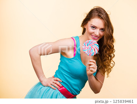 Woman joyful girl with lollipop candy Woman joyful girl with lollipop candy 125839461