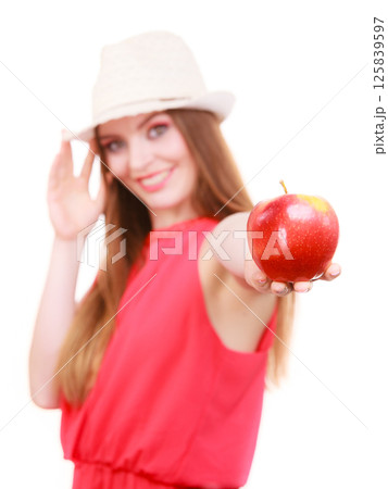 Woman summer hat colorful makeup holds apple fruit Woman summer hat colorful makeup holds apple fruit 125839597