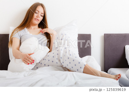 Tired girl hugging pillow. Tired girl hugging pillow. 125839619