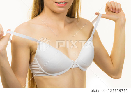 Young woman holding bra strap 125839752