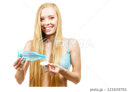 Woman using cleanser cosmetic 125839791