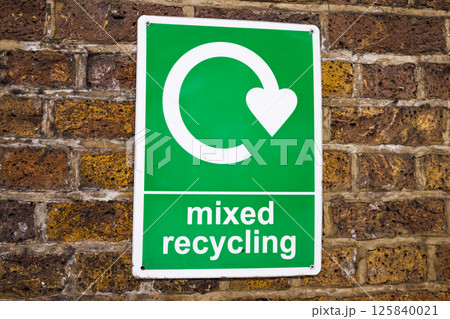 Mixed recycling sign on brick wall promoting eco friendly waste segregation and recycling Mixed recycling sign on brick wall promoting eco friendly waste segregation and recycling 125840021