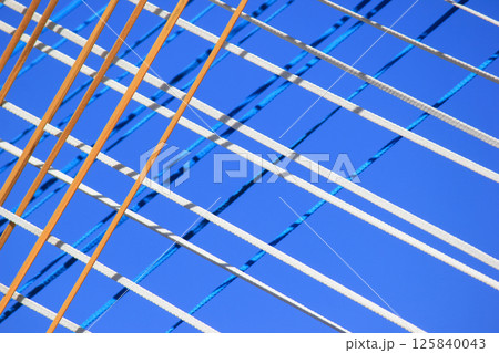 The ropes are brightly colored against the blue sky. 125840043