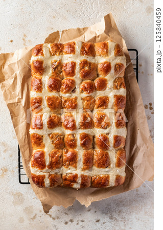 Freshly baked traditional Easter hot cross buns. Delicious Easter breakfast. Top view Freshly baked traditional Easter hot cross buns. Delicious Easter breakfast. Top view 125840459