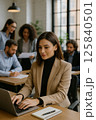 Female Professional Using Laptop in Stylish Modern Office Environment 125840501