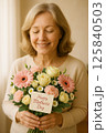 Smiling Woman Holding a Lovely Mothers Day Bouquet of Flowers 125840503
