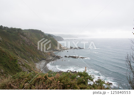 Aerial view of asturian coast on cloudy day. Near San Juan de la Arena, Asturias, Spain Aerial view of asturian coast on cloudy day. Near San Juan de la Arena, Asturias, Spain 125840553