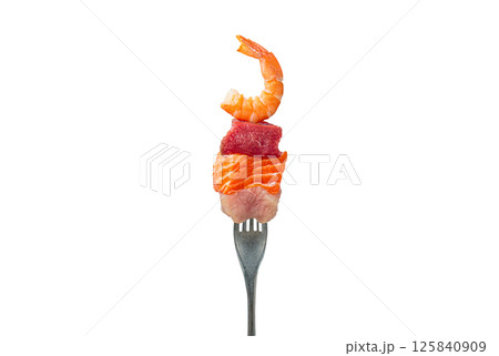 Fork holding pieces of raw salmon, beef, chicken and shrimp representing protein sources isolated on white background Fork holding pieces of raw salmon, beef, chicken and shrimp representing protein sources isolated on white background 125840909