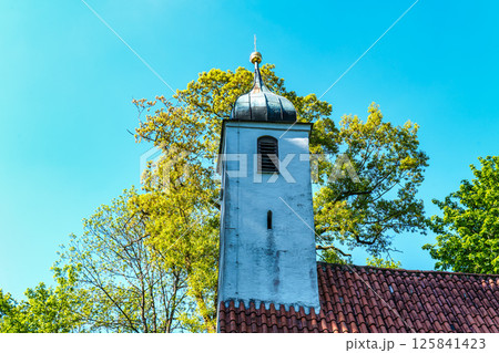 Church St.Clemens in Kranzberg near Freising, Bavaria with ancient graveyard and beautiful old wrought iron crosses 125841423