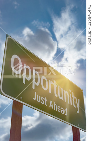 Opportunity Just Ahead Green Road Sign Against a Blue Sky and Clouds. 125841441