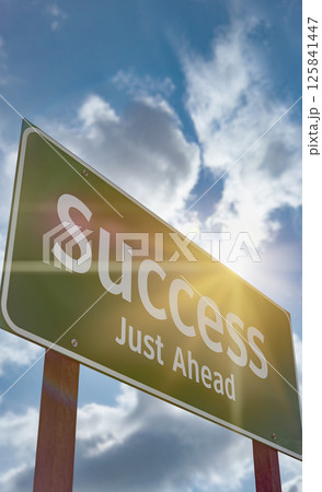 Success Just Ahead Green Road Sign Against a Blue Sky and Clouds. 125841447