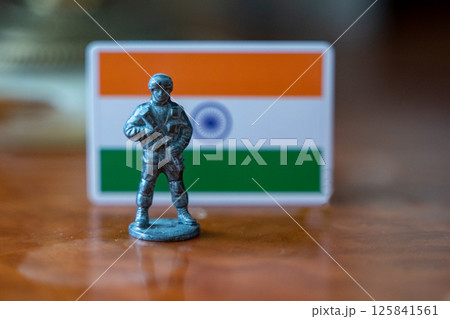 A tin soldier on the background of the Indian flag. India Pakistan military conflict 125841561