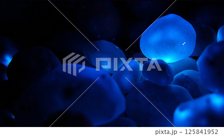 Blue stones glow underwater at night 125841952