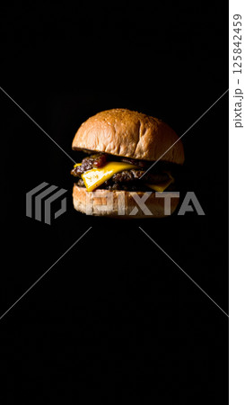 Great burger on a dark isolated phone 125842459