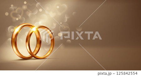Scene with two gold wedding rings and small hearts. 125842554