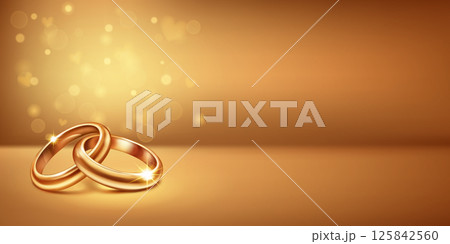 Intertwined gold wedding rings and small hearts. Intertwined gold wedding rings and small hearts. 125842560