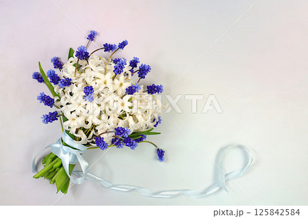 Beautiful bouquet of white hyacinth and muscari. Abstract flower arrangement for screen and design template. Spring greeting card, elegant beauty concept, gift for loved ones, Beautiful bouquet of white hyacinth and muscari. Abstract flower arrangement for screen and design template. Spring greeting card, elegant beauty concept, gift for loved ones, 125842584
