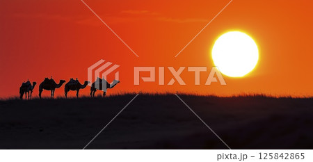 Camel caravan silhouetted against blazing orange sunset in desert landscape, copy space 125842865