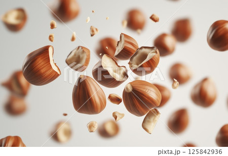 Hazelnut splash with cracked nuts and flying pieces isolated on white background with copy space 125842936