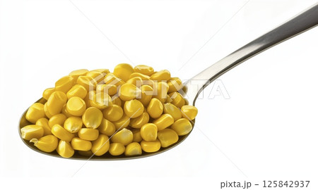 Corn kernels on metal spoon isolated on white background with clipping path Corn kernels on metal spoon isolated on white background with clipping path 125842937