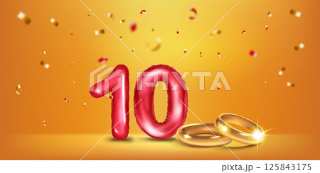 Red number 10, gold wedding rings and confetti. 125843175