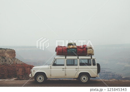 Adventurous SUV with Luggage on Roof at Scenic Canyon View During Vacation Trip Adventurous SUV with Luggage on Roof at Scenic Canyon View During Vacation Trip 125845343