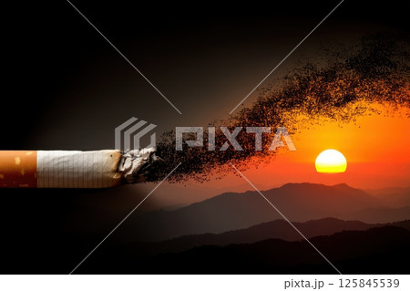 Pixelated Trail of Smoke from a Cigarette against a Sunset Background Over Mountains 125845539