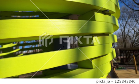 Green spiral structure in outdoor playground on sunny day 125845840