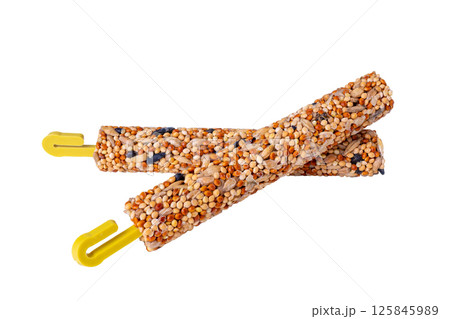 Colorful sticks of seeds and honey, sticks with yellow hooks, for rodents Colorful sticks of seeds and honey, sticks with yellow hooks, for rodents 125845989