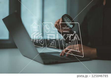 Digital inspection of business reports and performance charts using modern analytics tools. 125846785