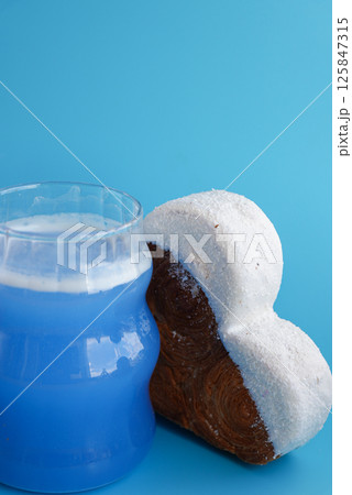 Blue drink Matcha beverage superfood Heart shaped flavor croissant on blue background with copy space. Puff pastry new trendy sweet dessert bakery. Creamy dough 125847315