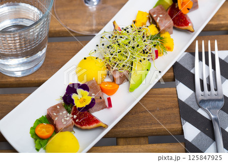 Delicious roasted tuna served with mango Delicious roasted tuna served with mango 125847925