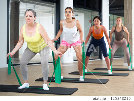 Group of women doing stretch exercises 125848210