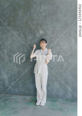 ガッツポーズをする若手看護師 125848402